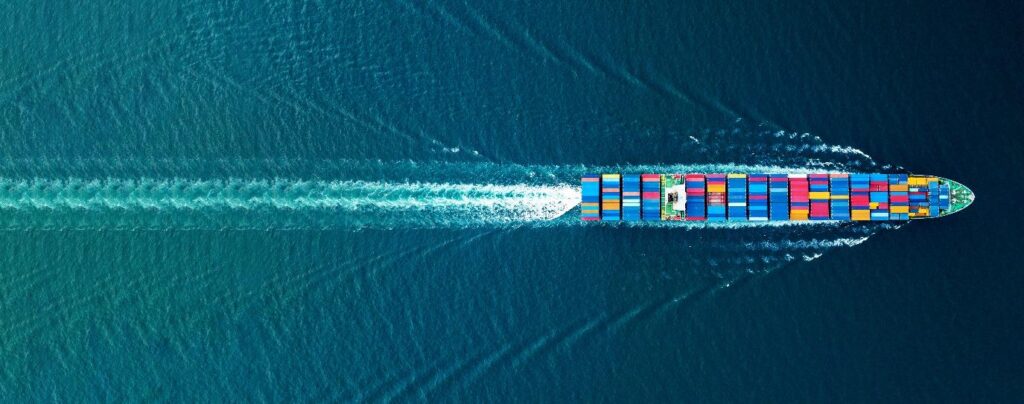 Aerial view of a container cargo ship in the ocean.