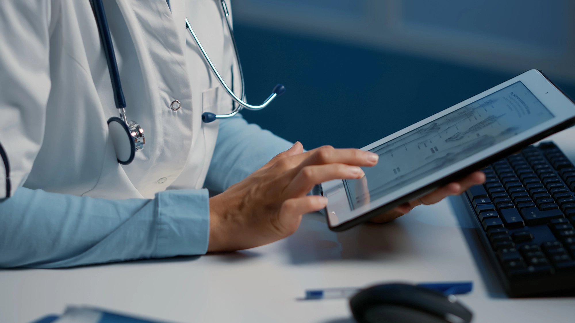 Medical professional working on a tablet.
