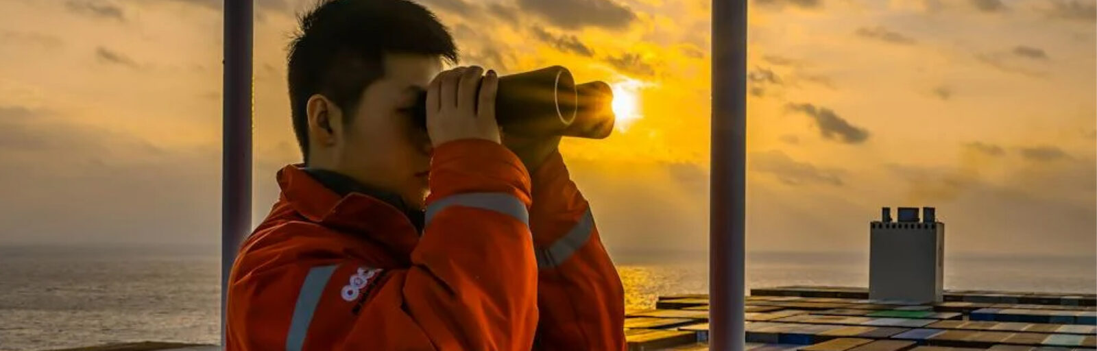 Sailor looking through binoculars